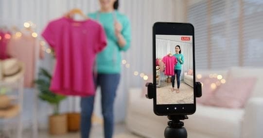 A person taking a picture of a person in front of a phone
AI-generated content may be incorrect.